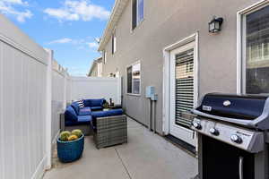 Fenced patio featuring an outdoor hangout area.