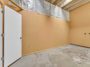 Unfinished basement with baseboards