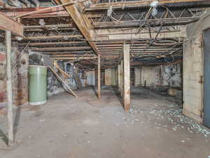 Unfinished below grade area featuring water heater