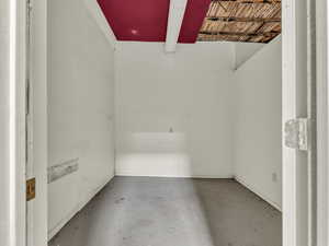 Unfurnished room featuring concrete flooring