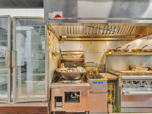 Kitchen featuring stainless steel range with gas stovetop and wood finished floors