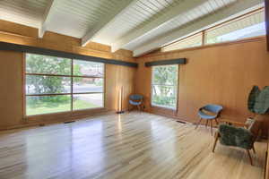 Unfurnished room with wood finished floors and wooden walls