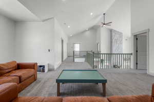 Second level large living area featuring ceiling fan, carpet, high vaulted ceiling, recessed lighting.