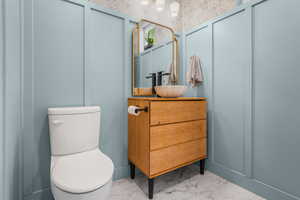 Main floor powder room located just off the mud room with access to the flex room