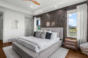 Main level Primary bedroom with ensuite and accent wall.