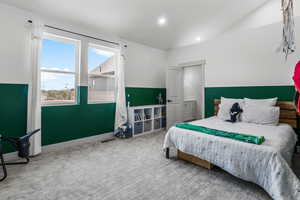 Bedroom with carpet floors, recessed lighting, and loft area.