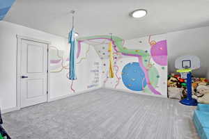 Playroom with carpet and a textured ceiling