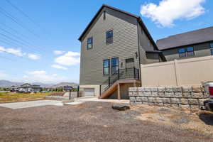 Back of house with apartment entry and parking.