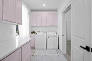 Second level laundry with custom cabinets.