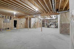 Unfinished basement featuring stairway