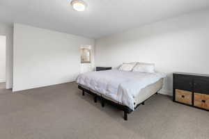 Carpeted bedroom featuring baseboards
