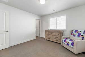Bedroom with carpet floors and baseboards