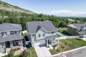 Aerial view of property and surrounding area with a mountain backdrop