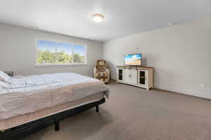 Carpeted bedroom with baseboards