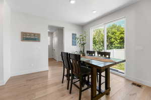 Dining space featuring baseboards, light wood-type flooring, and recessed lighting
