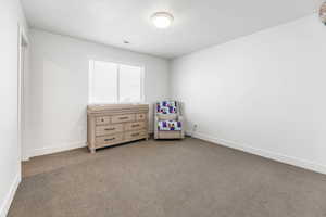 Carpeted bedroom featuring baseboards