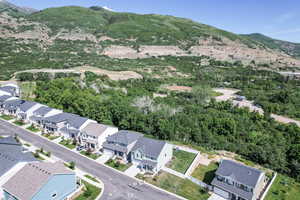 Aerial view of property's location with mountains and nearby suburban area