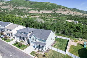 Aerial view of property and surrounding area featuring a mountain backdrop