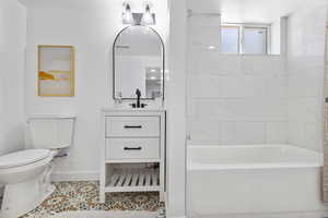 Full bath featuring tile patterned flooring, vanity, and bathtub / shower combination