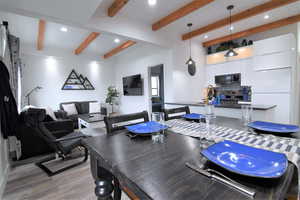 Dining room with recessed lighting, light wood-style floors, and beam ceiling