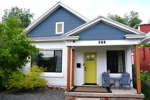 View of front of property with covered porch and brick siding