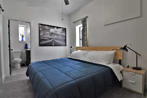 Bedroom featuring ensuite bath and ceiling fan