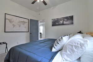 Carpeted bedroom featuring ceiling fan