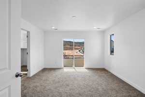 Unfurnished room featuring carpet and baseboards