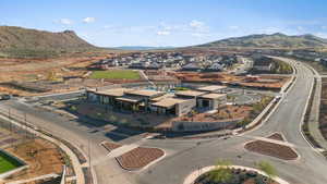 Aerial view of property and surrounding area with mountains and nearby suburban area