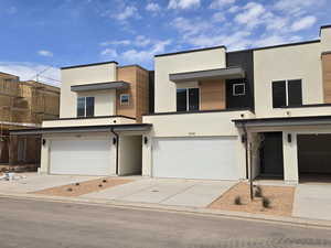 Contemporary home with a garage and stucco siding