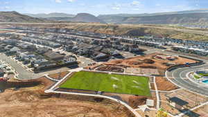 Aerial perspective of suburban area featuring a mountain backdrop