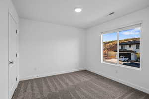 Spare room with carpet floors and baseboards
