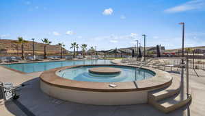 Community pool with a hot tub and a patio area