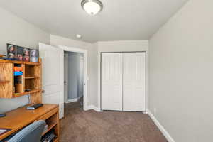 Carpeted office featuring baseboards