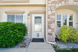 Property entrance with stucco siding and stone siding