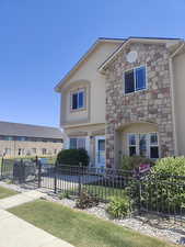 View of front of house featuring stone siding and stucco siding