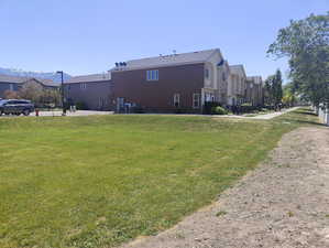 Back of property with a residential view and a yard
