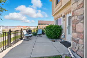 View of patio with a balcony