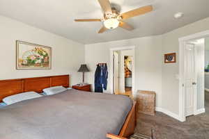 Bedroom with carpet, baseboards, and ceiling fan