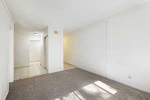 Carpeted empty room with tile patterned flooring