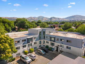 View of building exterior with uncovered parking and a mountain view