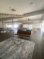 Living room featuring ceiling fan and wood finished floors