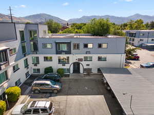 View of building exterior featuring uncovered parking and a mountain view