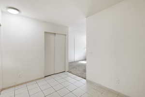 Dinning room  or office with light tile patterned floors and light carpet