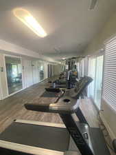 Exercise room featuring wood finished floors