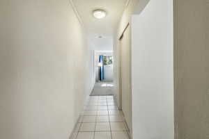 Corridor featuring light tile patterned floors