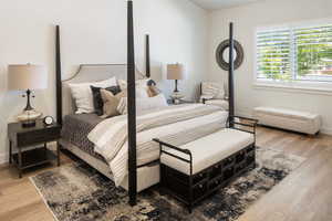 Bedroom featuring wood finished floors and baseboards