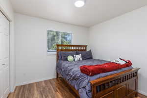 Bedroom featuring wood finished floors and baseboards