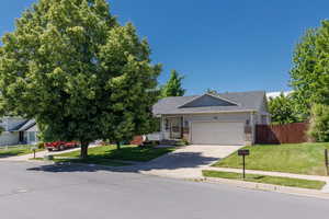 View of front of home featuring a garage, brick siding, driveway, and roof with shingles