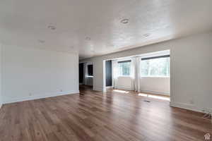 Spare room featuring wood finished floors and baseboards